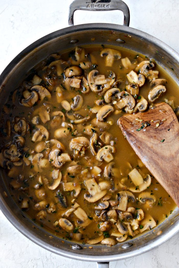 mushroom wine sauce starting to thicken in skillet.