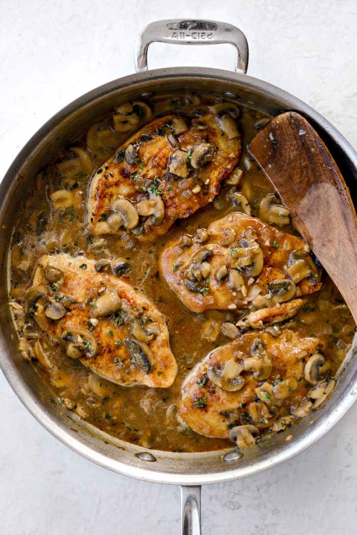 Lighter Chicken Marsala in skillet with fresh herbs on top.