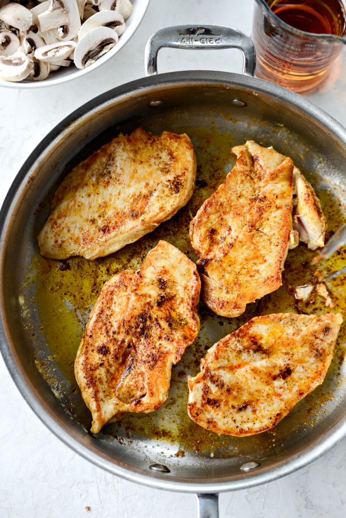 seared chicken breasts in skillet.