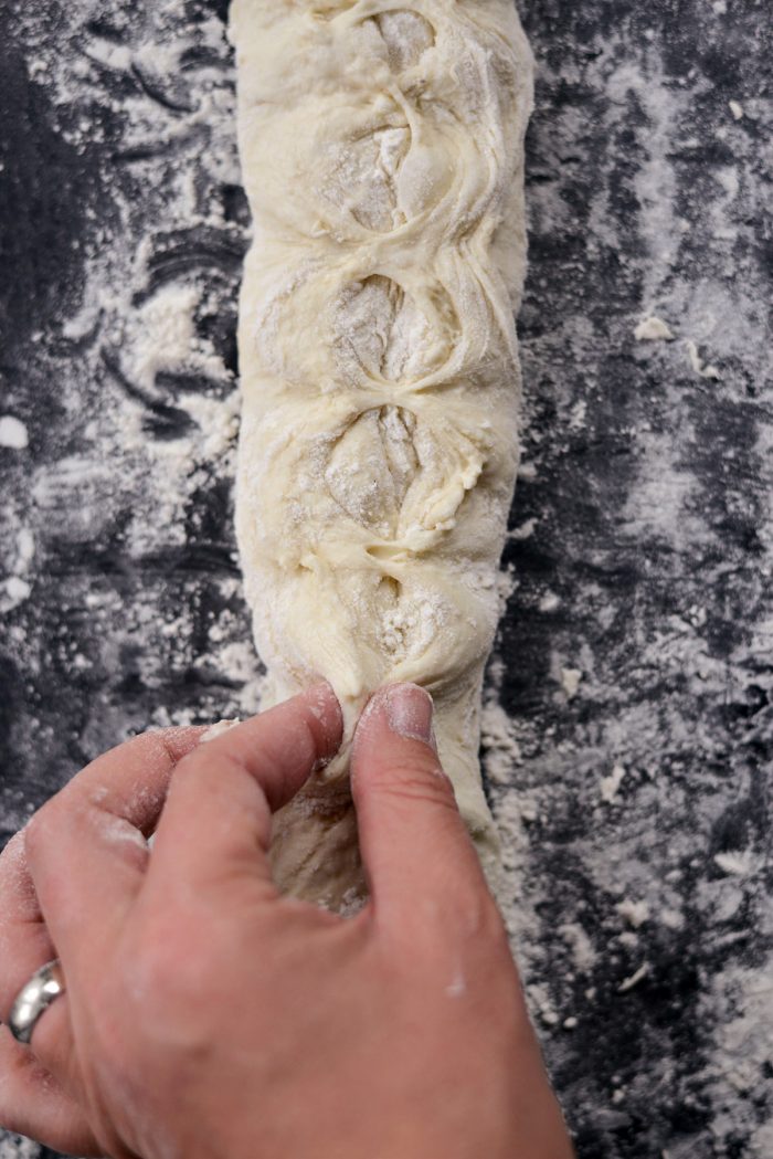 pinching dough with fingers,