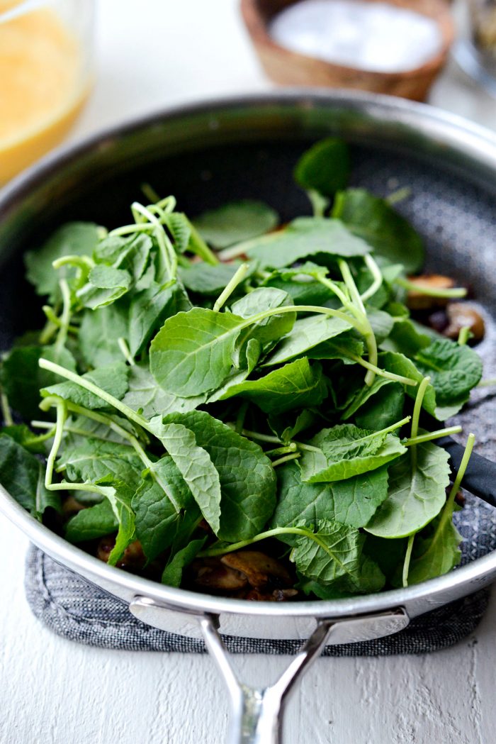 baby kale added to skillet.