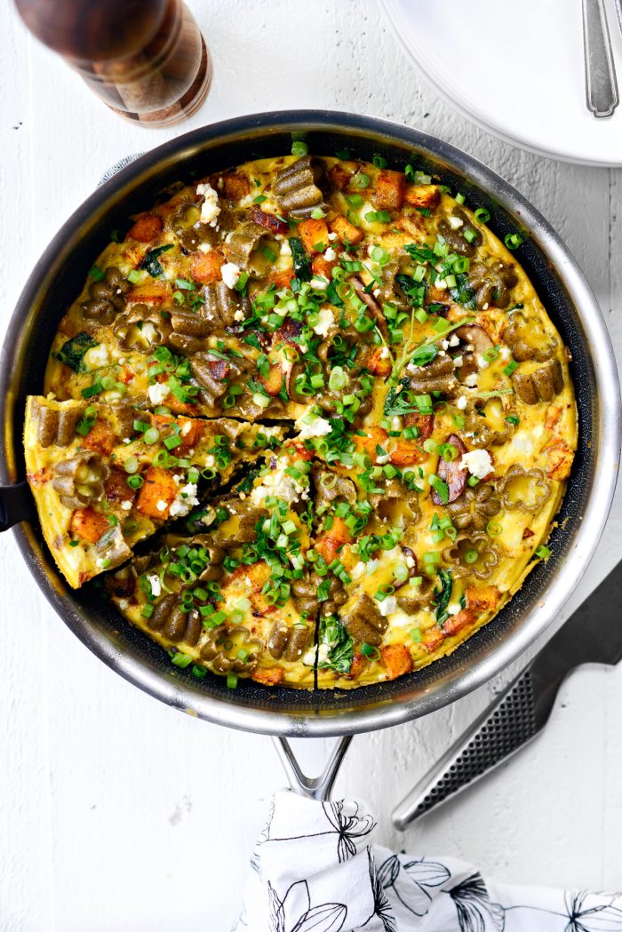 Roasted Pumpkin Kale and Feta Frittata topped with green onion and parsley.