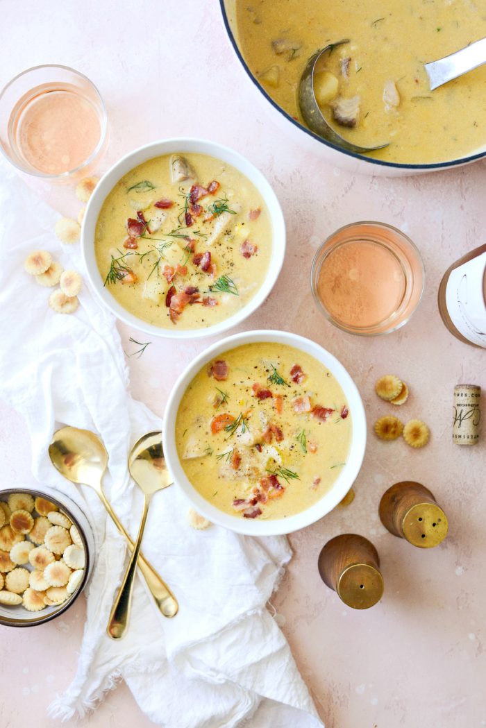 bowls of salmon chowder with glasses of rosè and oyster crackers.