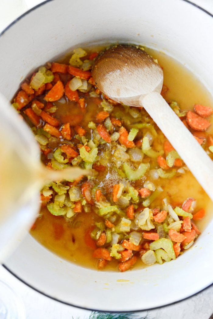 pouring broth into pot.