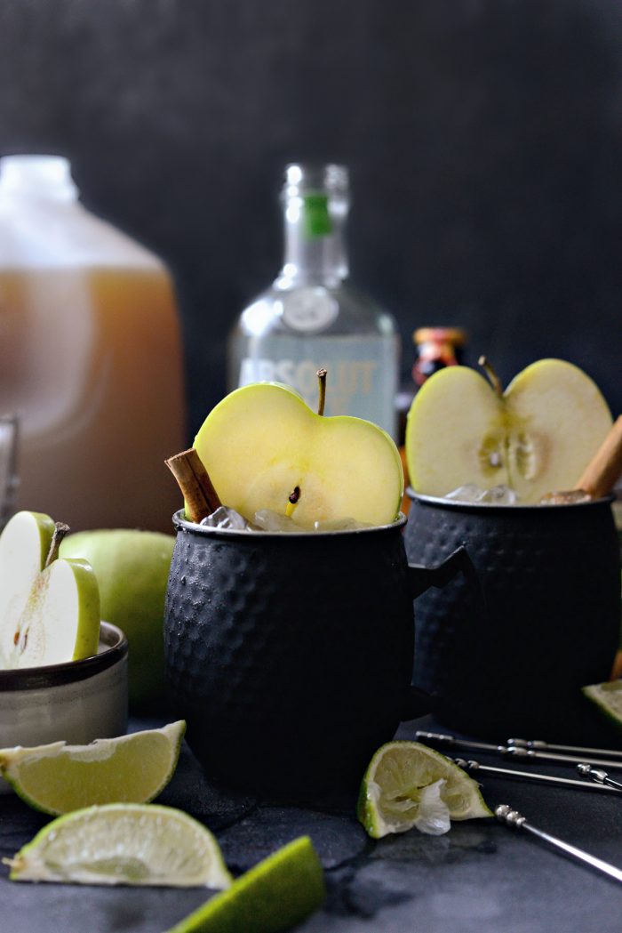 Apple cider Moscow mules in black metal cups.