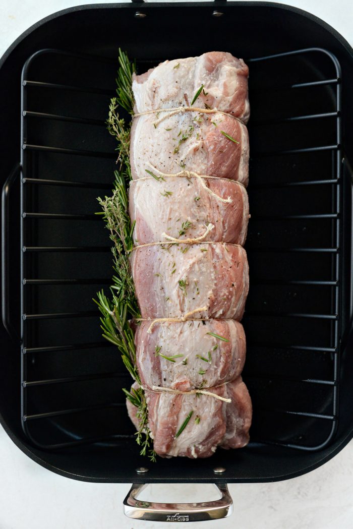 tied pork loin on roasting rack.