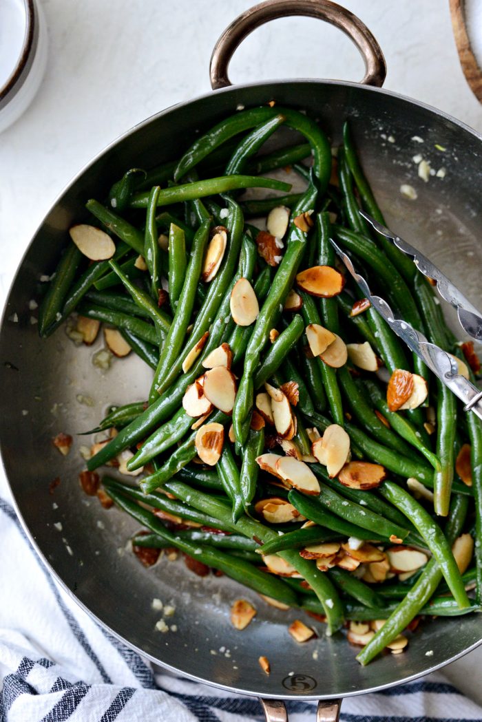 garlicky green beans almondine in skillet.