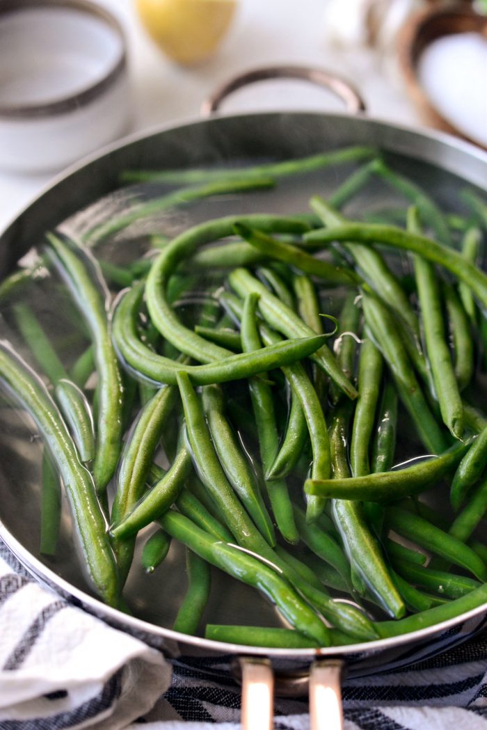 fresh green beans added to boiling water.