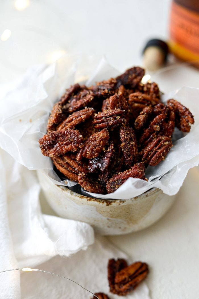 honey vanilla bourbon pecans in a bowl with wax paper.