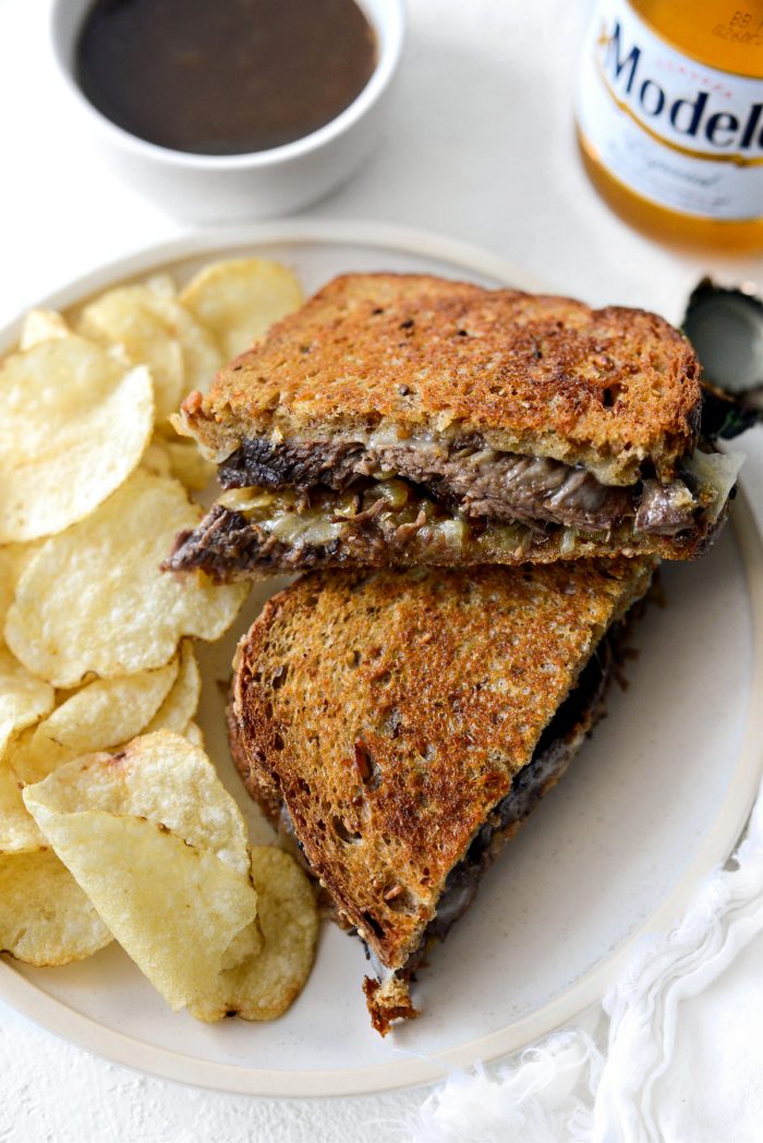 Leftover Pot Roast Cheddar Grilled Cheese Sandwich on a plate with kettle chips.