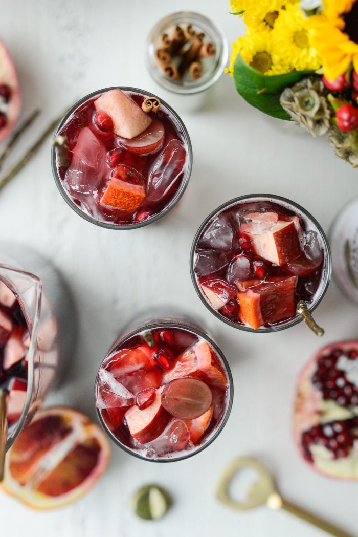 group shot of glasses and pitcher of pomegranate sparkling apple cider sangria