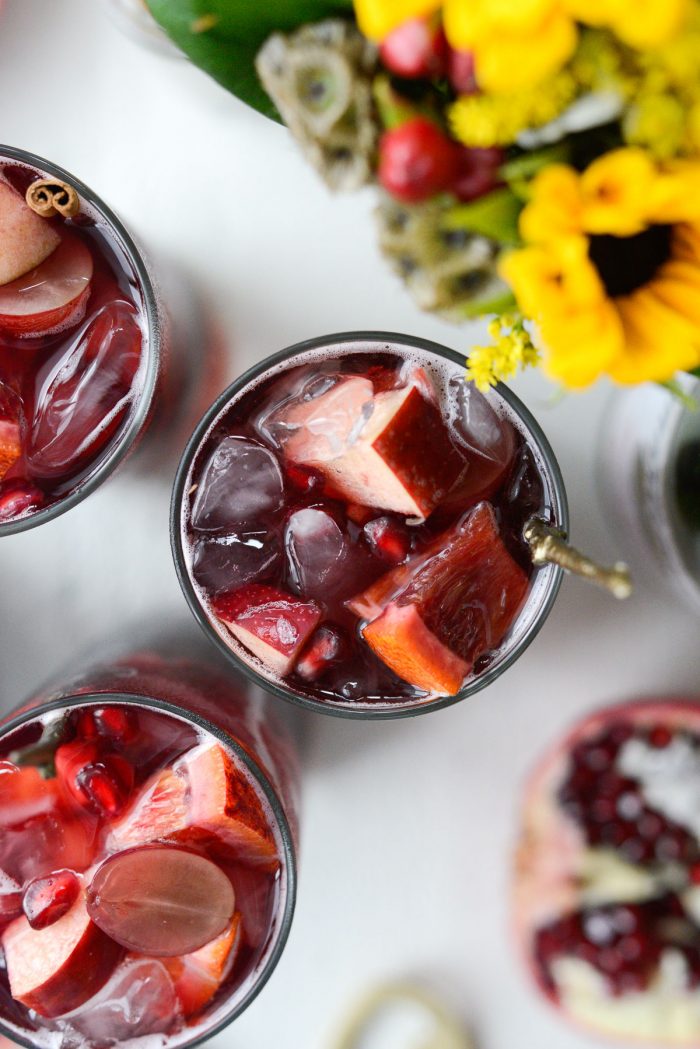 close up of fruit in glass of pomegranate sparkling apple cider sangria.