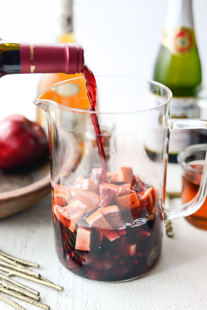 pouring wine into pitcher