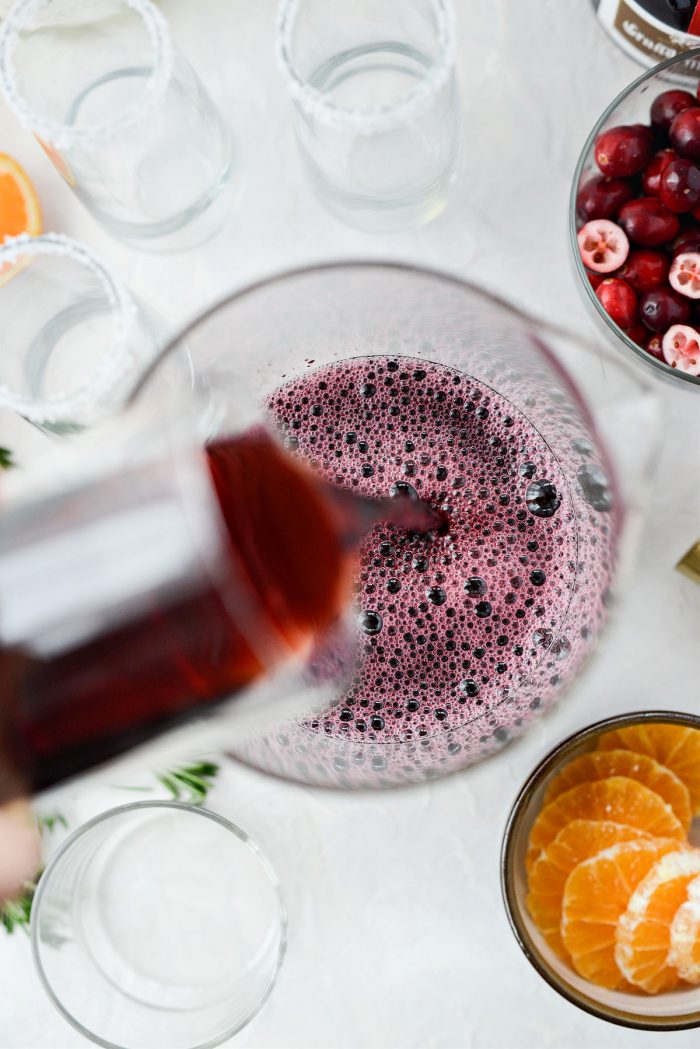 pour pomegranate juice into pitcher.