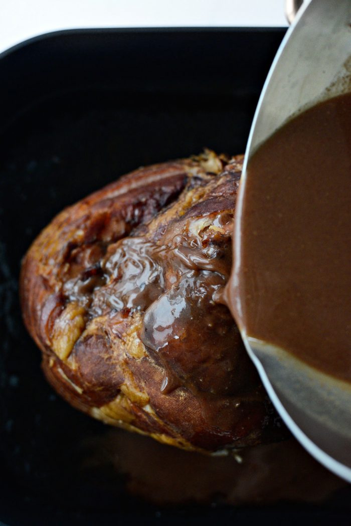 pouring glaze over ham