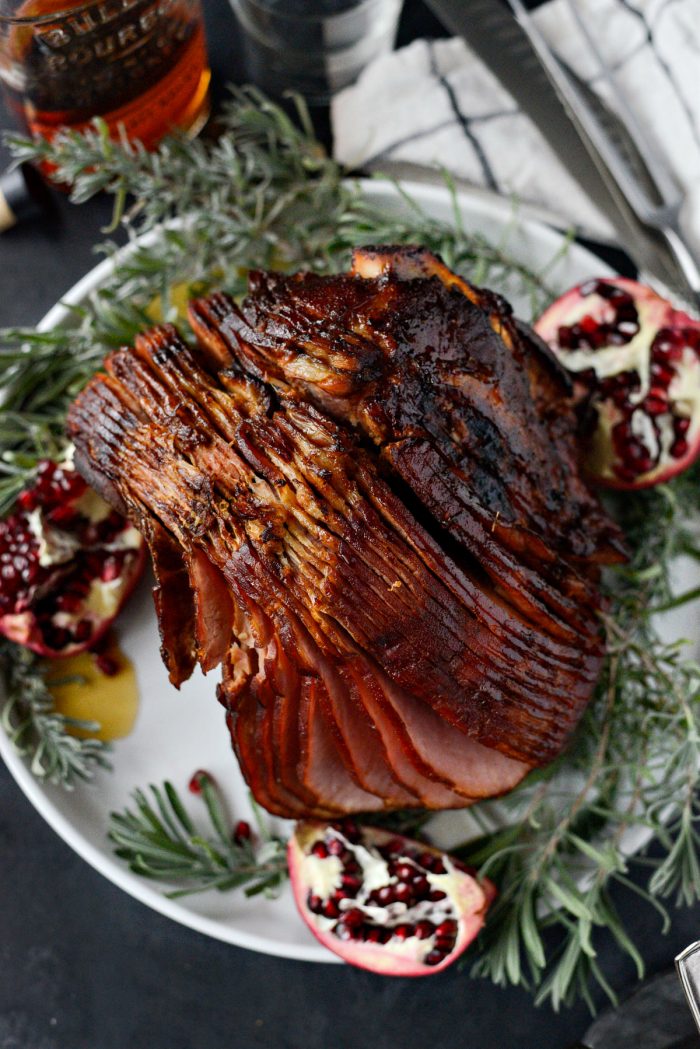 Pomegranate Bourbon Glazed Ham on platter with pomegranate halves