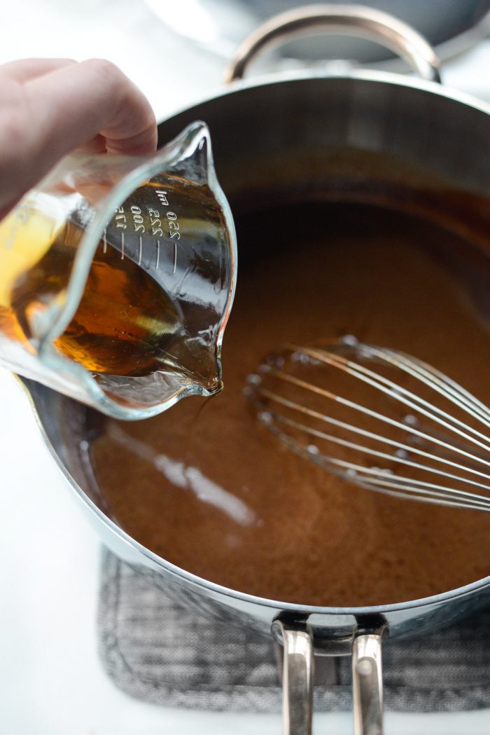 pouring remaining bourbon in glaze.