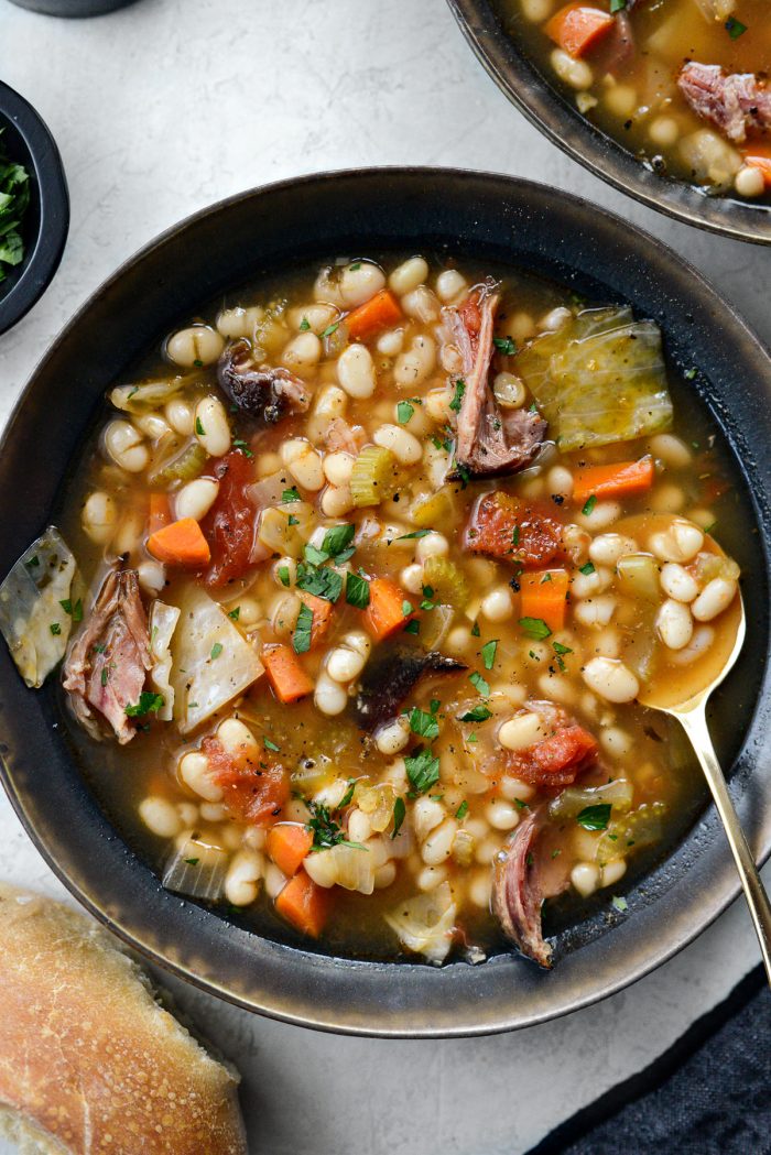 Rustic Ham and Bean Soup in black and gold bowl.