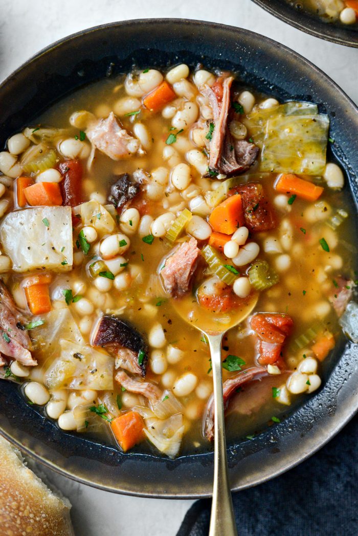 gold spoon in bowl of Rustic Ham and Bean Soup.