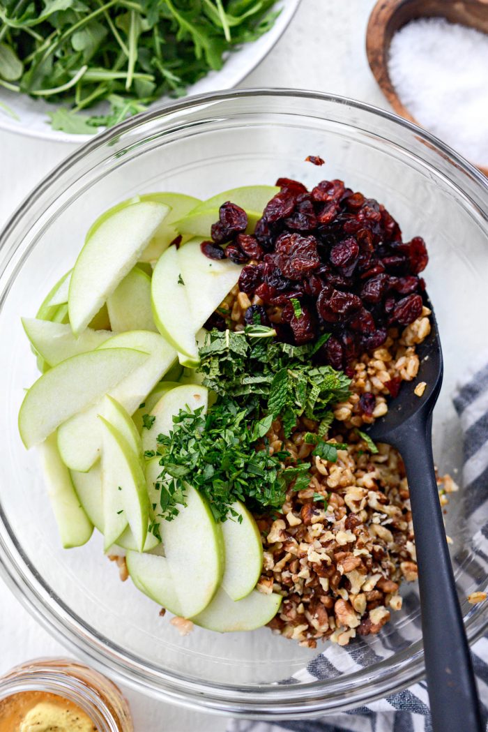 farro, cranberries, apples and herbs in bowl.