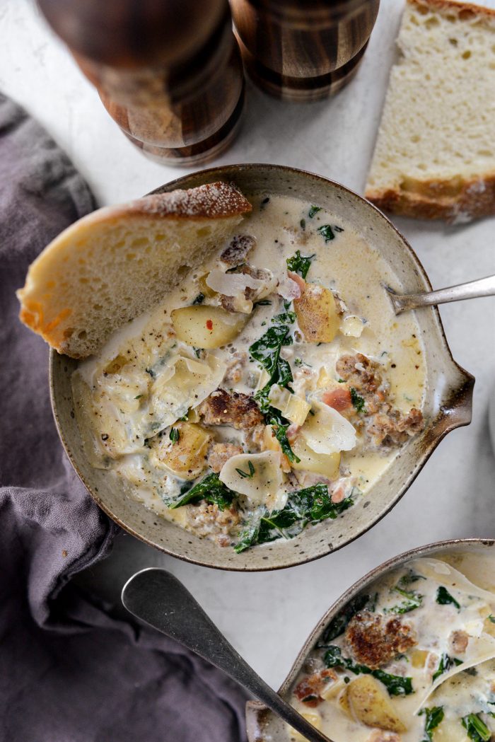 rustic bowl of Zuppa Toscana with bread.