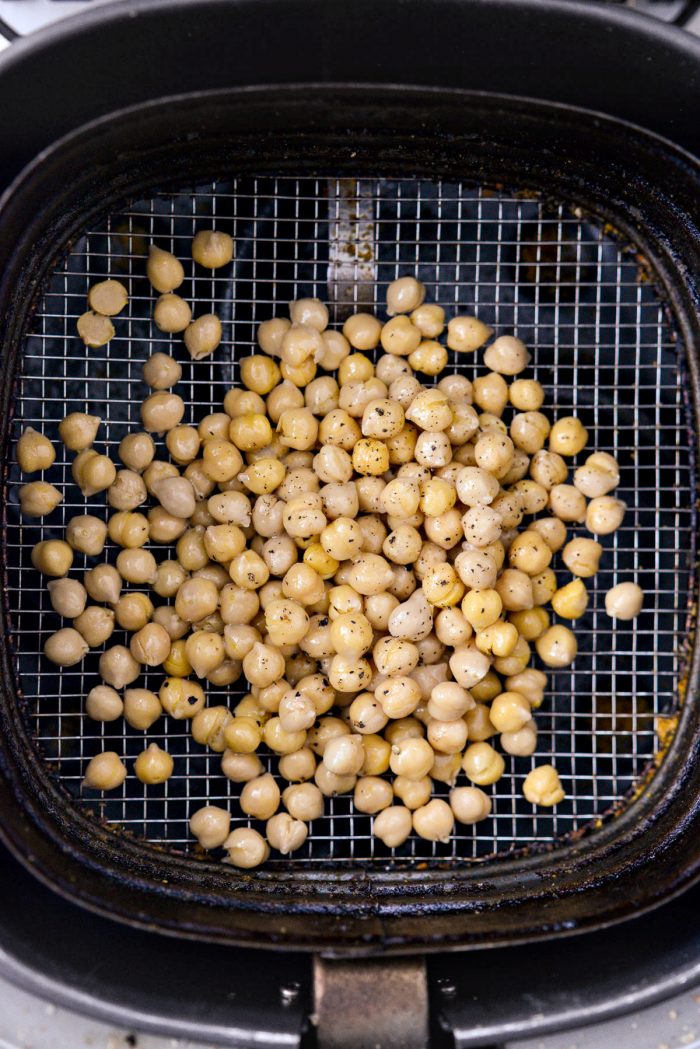 add beans, spray with oil and season with fine salt and black pepper