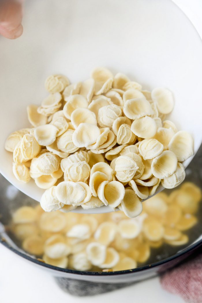 adding orecchiette to broth.