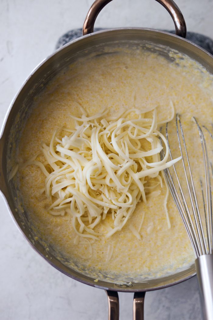 grated fontina added to grits