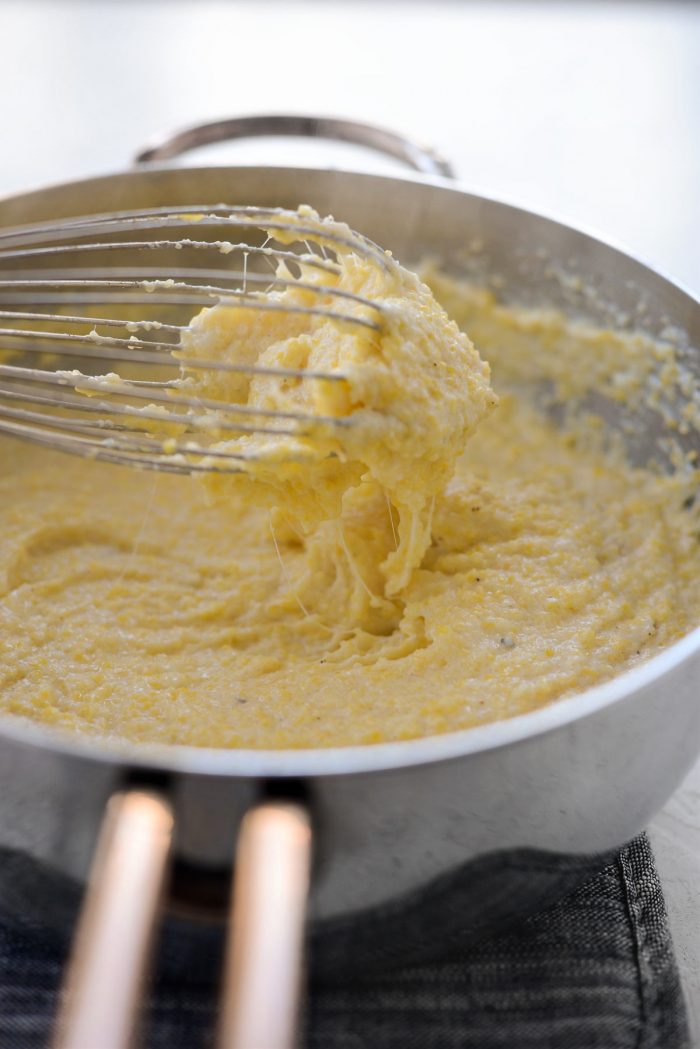 whisk with cheesy fontina grits