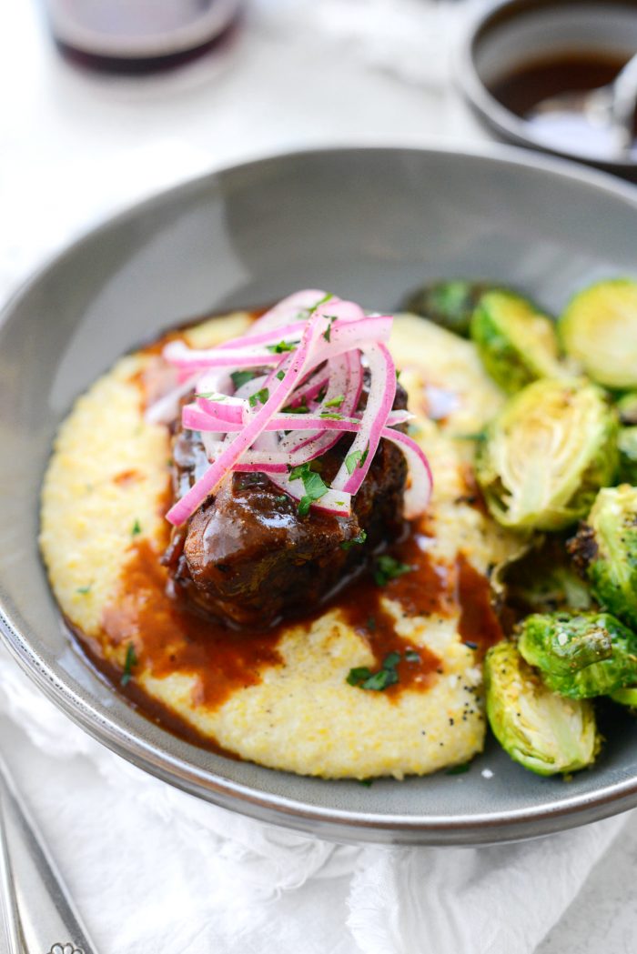Wine Braised Pork Shoulder on cheesy fontina grits with roasted Brussels sprouts