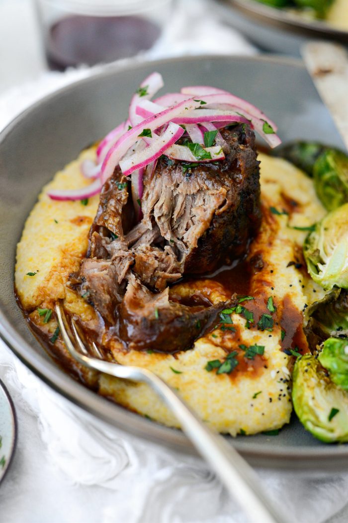 Wine Braised Pork Shoulder on cheesy grits with Brussels sprouts