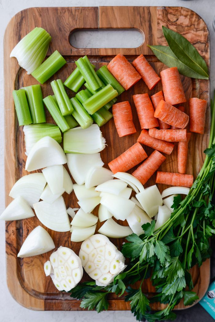 roughly chopped onion, carrots and celery with herbs and halved garlic.