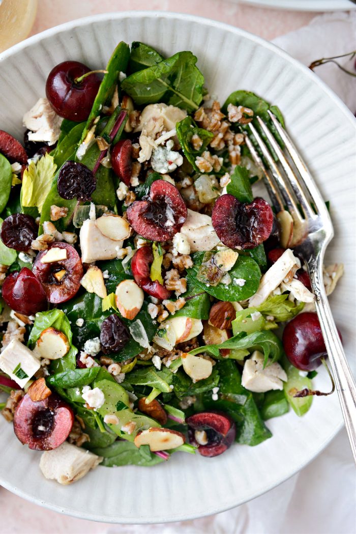 Cherry Winter Wheat Berry Salad in cream bowl with silver fork