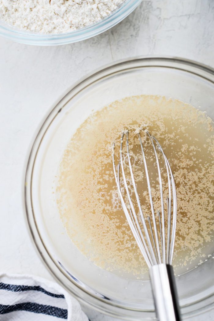 water honey and yeast in a glass bowl