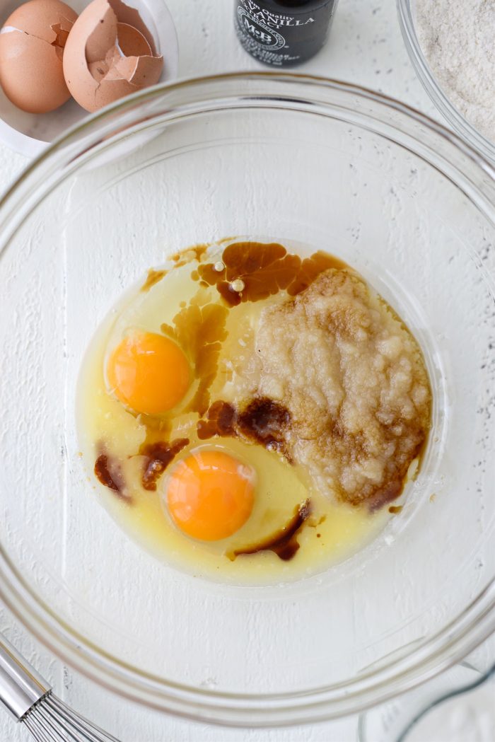 eggs, applesauce, butter and eggs in glass mixing bowl
