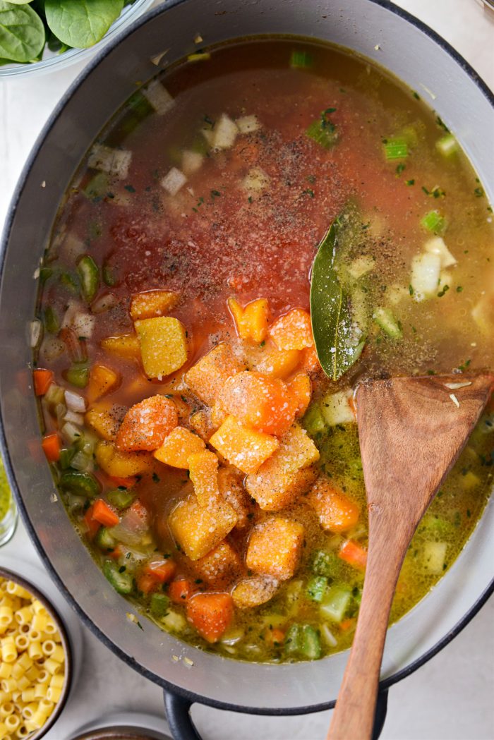 broth, crushed tomatoes, squash and bay added to pot.