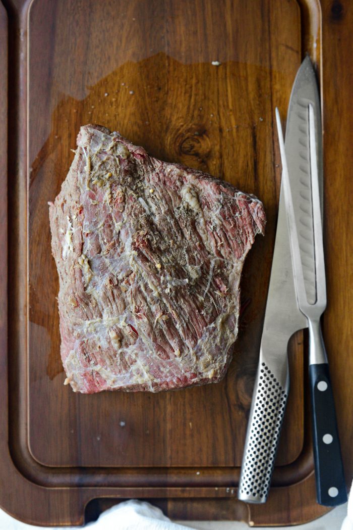 cooked corned beef on carving board