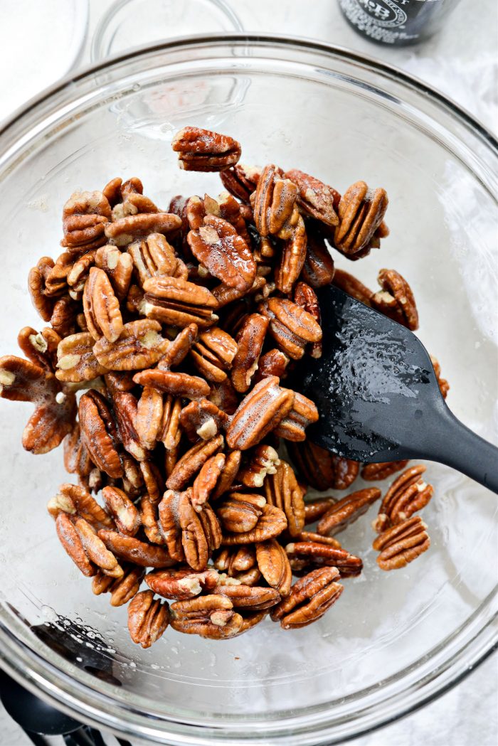 toss pecans in vanilla egg white mixture