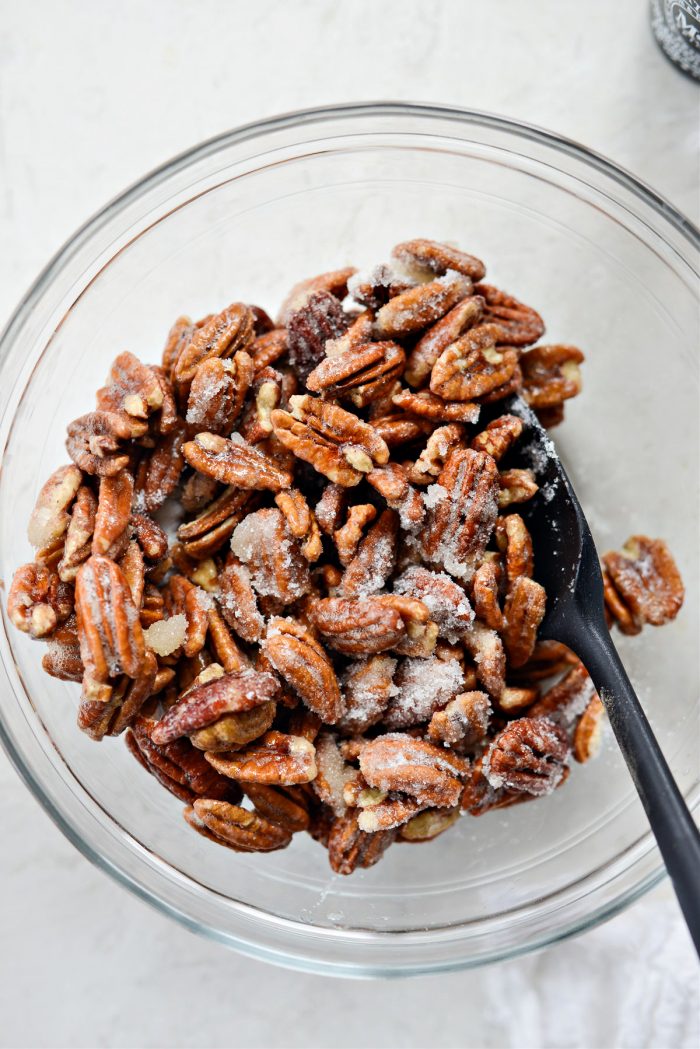 toss egg white coated pecans in sugar