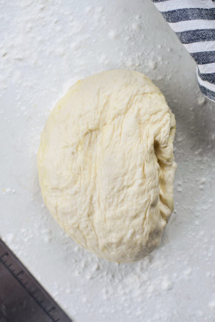 turn pizza dough out onto a floured surface