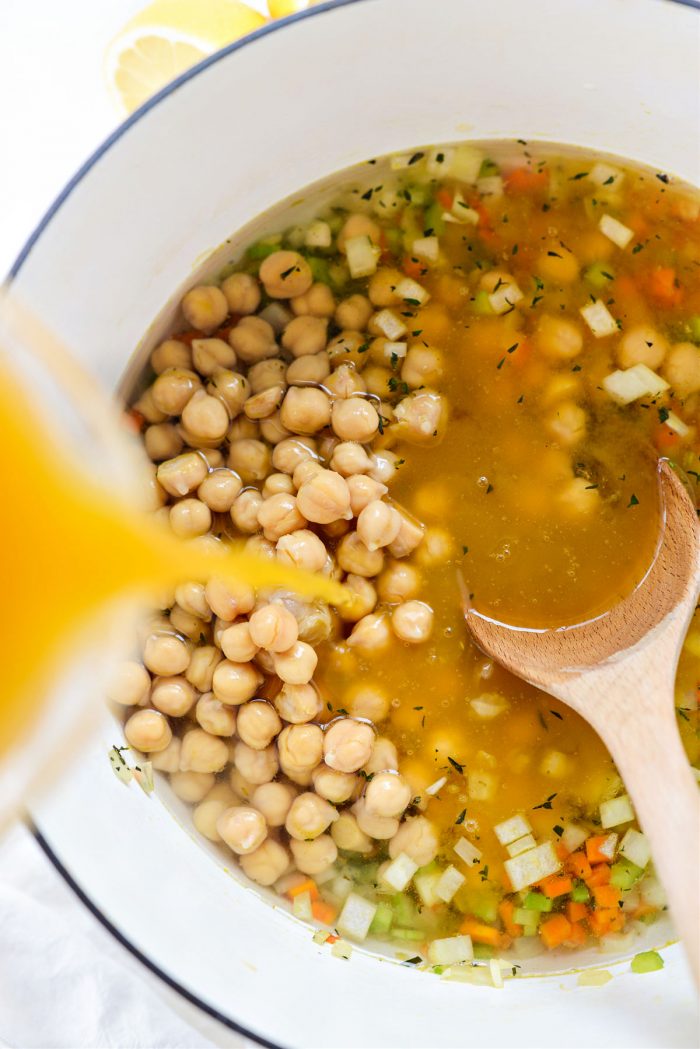 pouring broth and water into pot