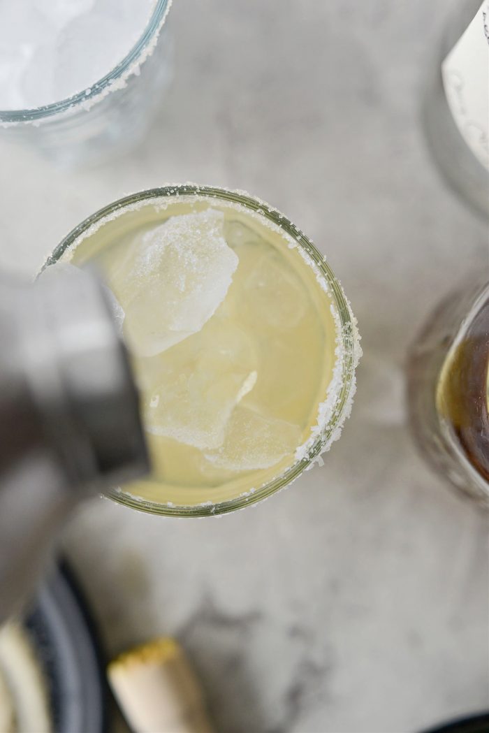 pour margarita into glasses