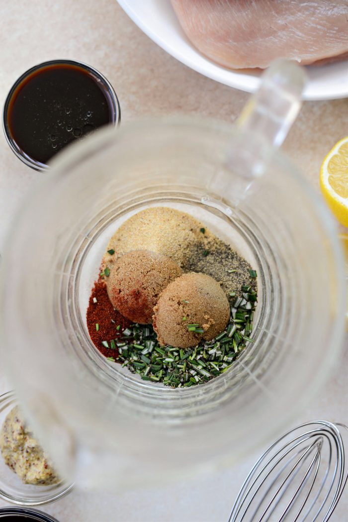 sugar, rosemary and spices in a glass liquid measuring cup