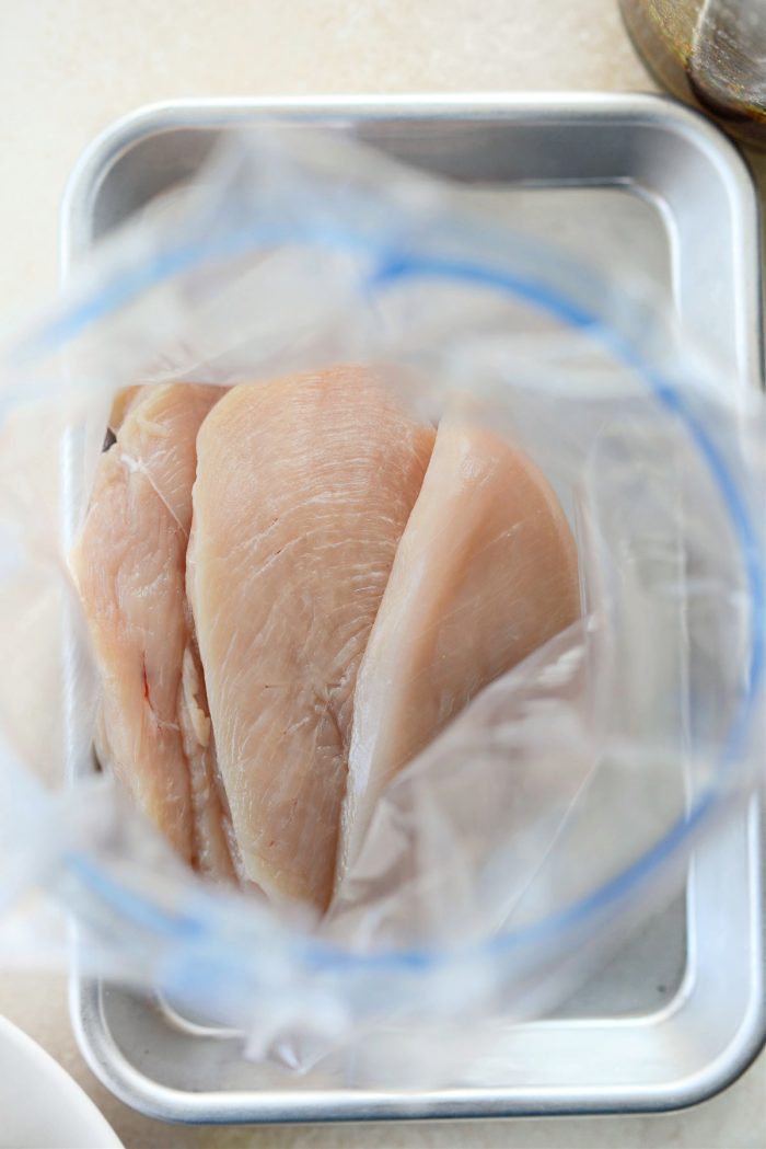 place chicken breasts into resealable bag or a glass bowl.
