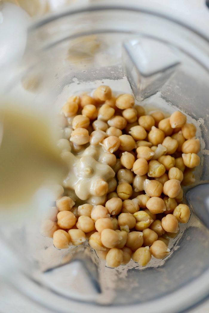 add chickpeas to blender and add tahini