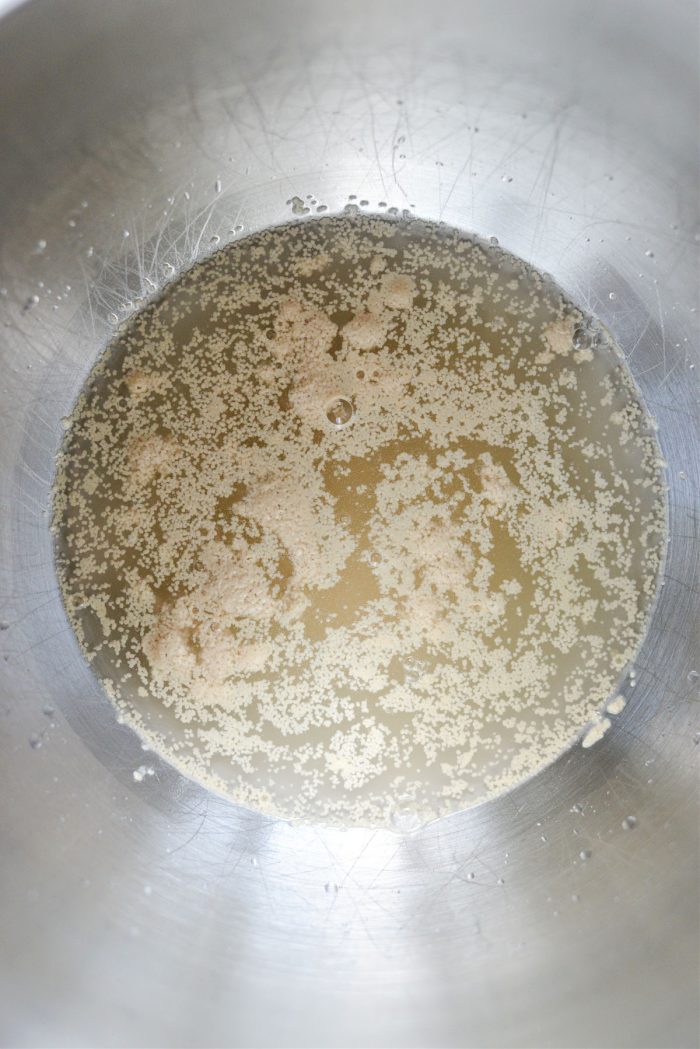 sugar, water and yeast in mixing bowl