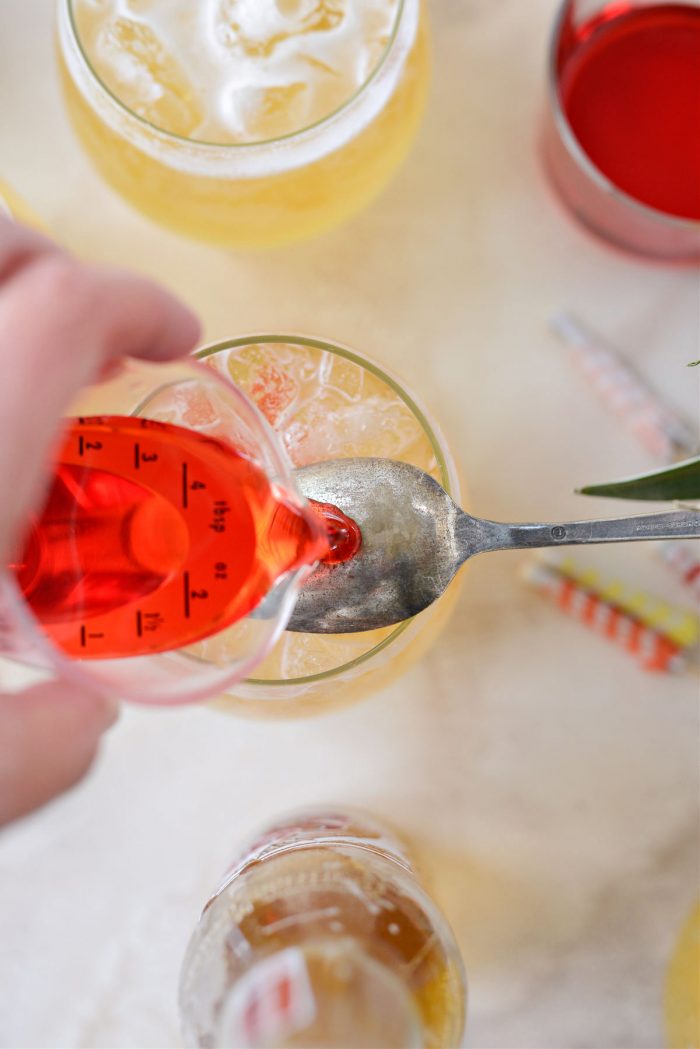 pouring grenadine over back of spoon