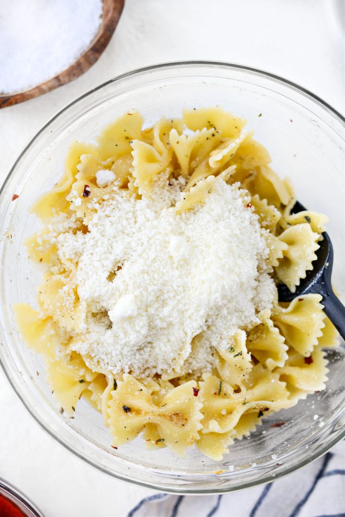 grated pecorino romano added to seasoned pasta