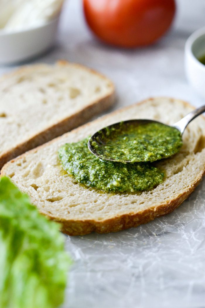 spread one side of bread with pesto