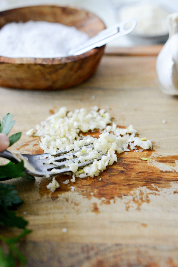 mash garlic and salt with fork